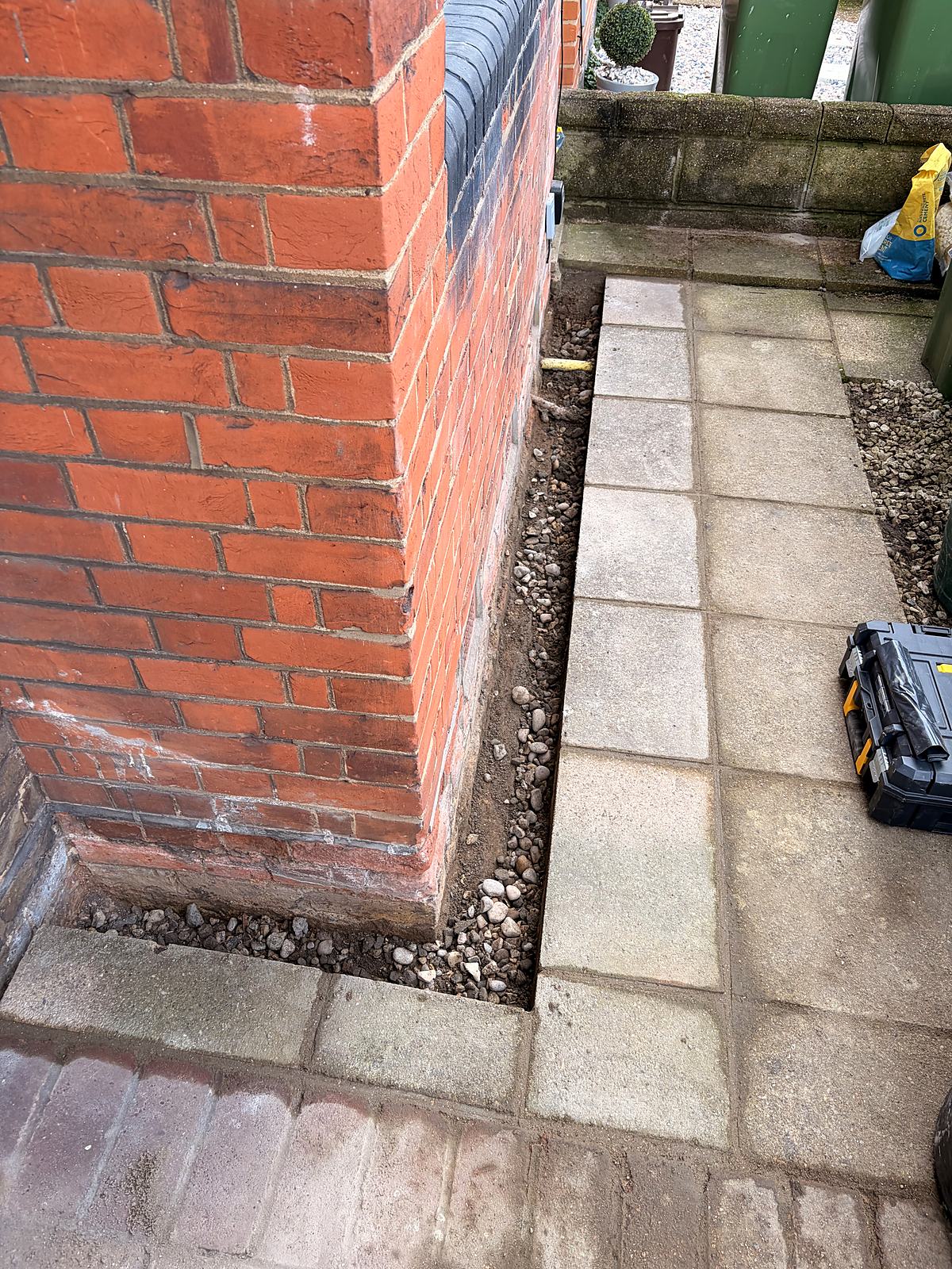 Paving cut back from the wall to protect the damp-proof course