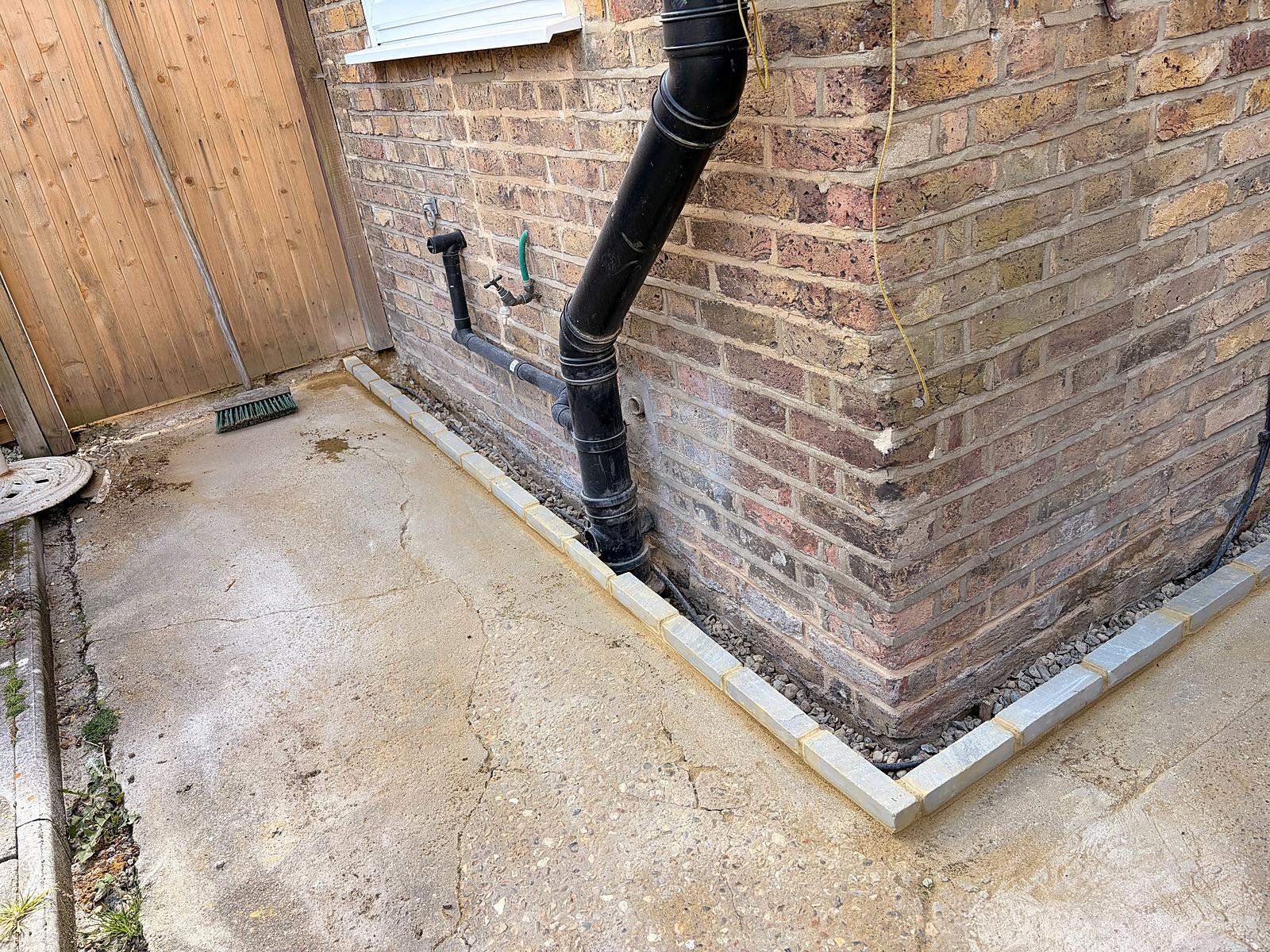 Paving cut back from the wall to protect the damp-proof course